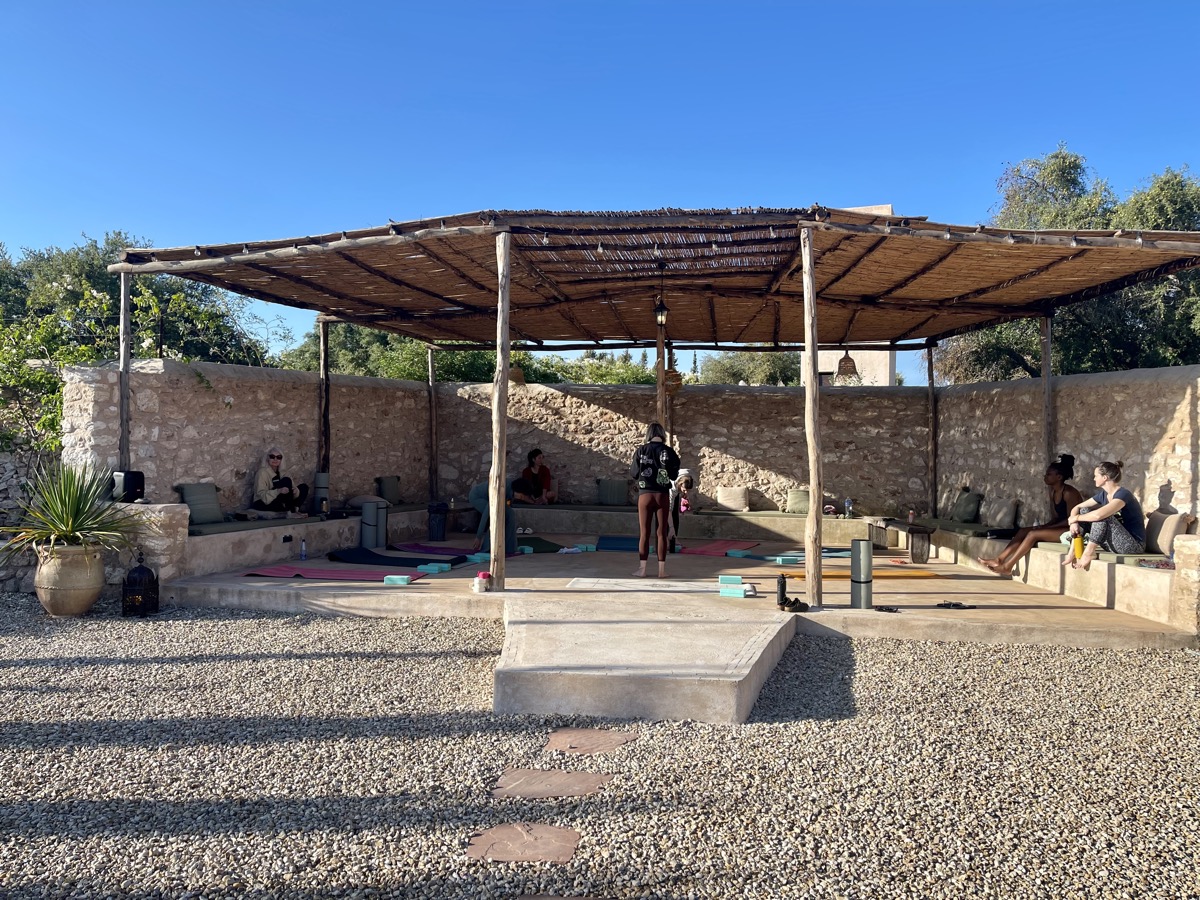 Guests practicing yoga under the shala at the villa